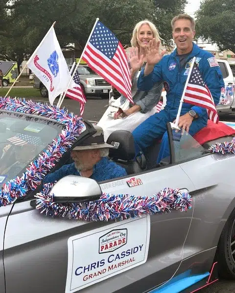 Grand Marshal Chris Cassidy Leading the Independence Day Parade Chris Cassidy wearing his NASA flight suit while serving as Grand Marshal of an Independence Day parade, engaging with the community to inspire the next generation of explorers.